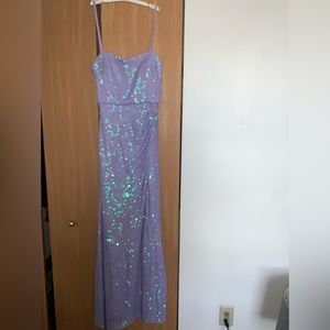 Purple prom mermaid dress with sequins and a slit up to mid thigh.